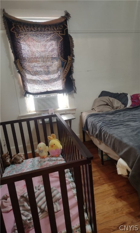 bedroom with hardwood / wood-style floors