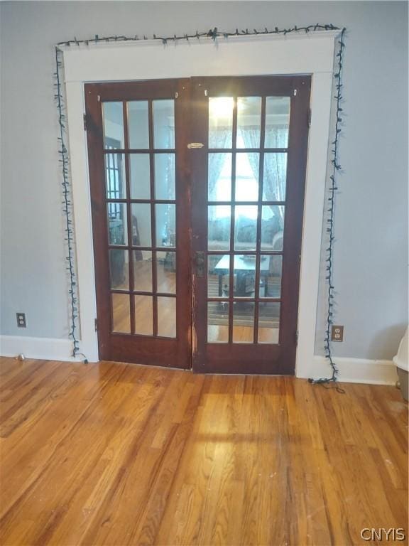 doorway to outside with wood-type flooring and french doors