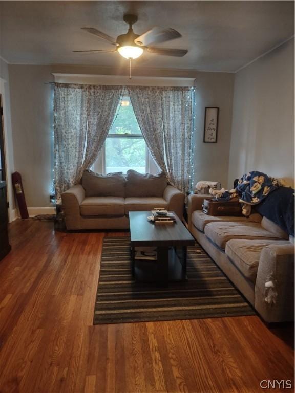 living room featuring hardwood / wood-style floors and ceiling fan