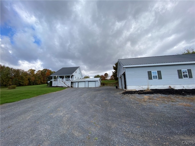 view of property exterior featuring a garage, a yard, and an outdoor structure