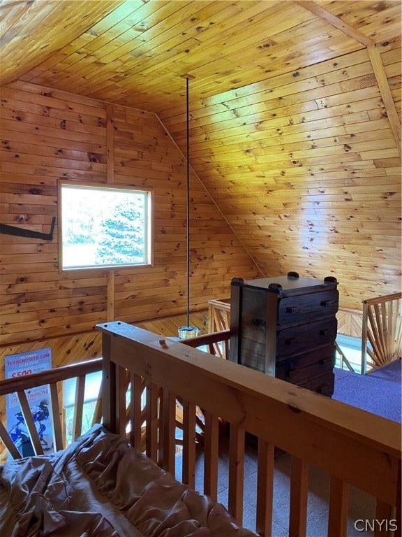 unfurnished bedroom featuring wood ceiling, wood walls, carpet, and vaulted ceiling