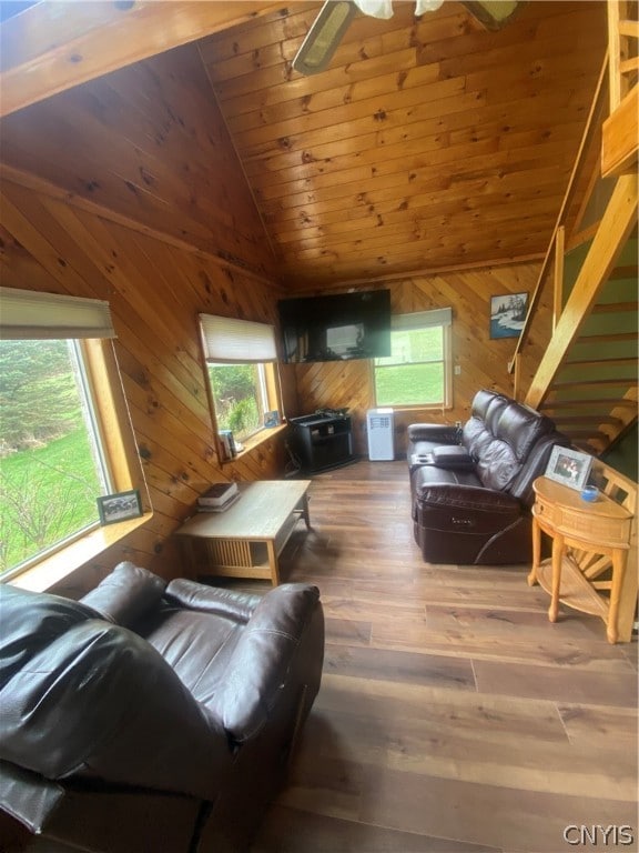 living room with hardwood / wood-style flooring, ceiling fan, high vaulted ceiling, wooden walls, and wood ceiling