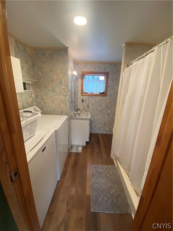 bathroom with vanity, hardwood / wood-style flooring, and independent washer and dryer