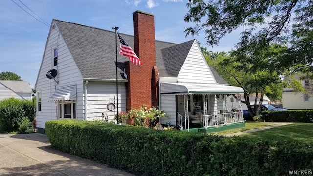 exterior space with a porch and a front yard