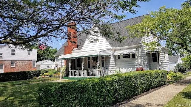 rear view of property featuring a yard