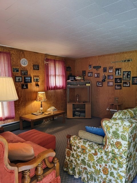 carpeted living room with wooden walls and a baseboard radiator