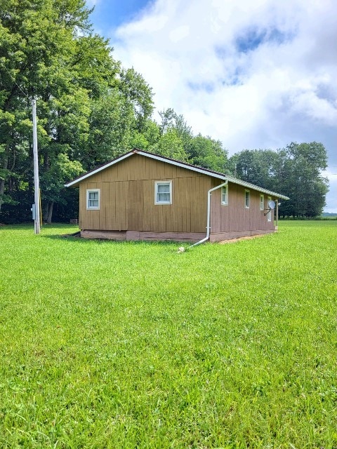 view of property exterior featuring a lawn