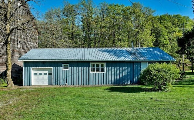 view of outbuilding featuring a garage and a lawn