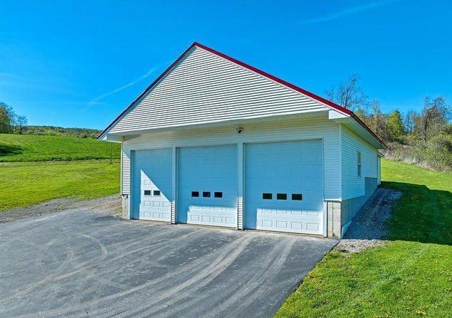 garage featuring a lawn