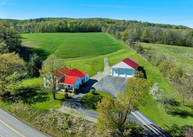 birds eye view of property with a rural view