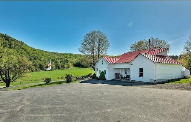 exterior space featuring a yard and a mountain view