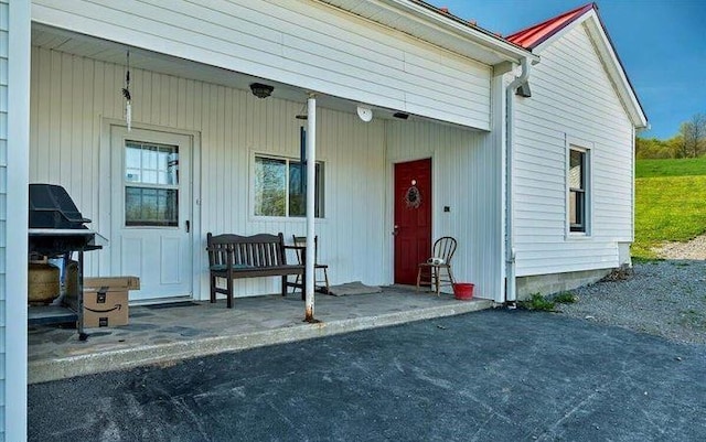 view of exterior entry featuring a porch