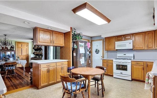 kitchen with white appliances and kitchen peninsula