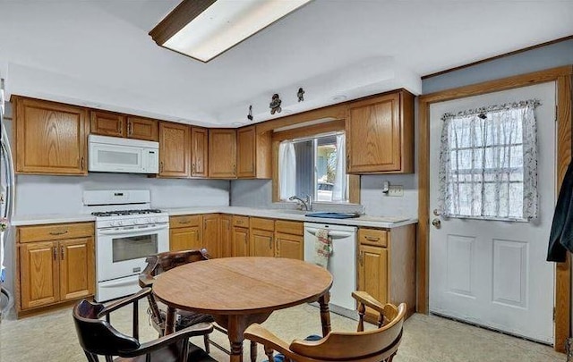 kitchen featuring white appliances and sink