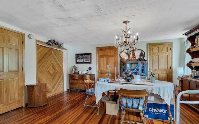 dining area with dark hardwood / wood-style flooring and a notable chandelier