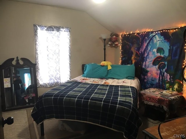 bedroom featuring vaulted ceiling and carpet