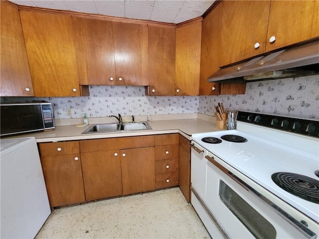 kitchen featuring sink, washer / dryer, and electric stove