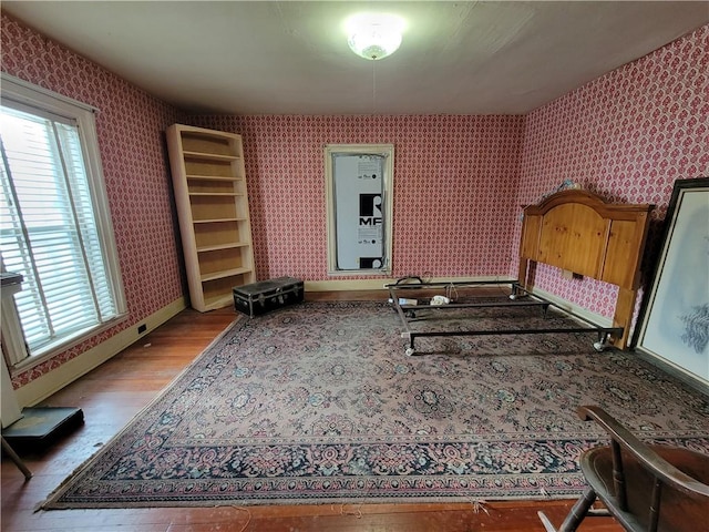 bedroom featuring multiple windows and light wood-type flooring