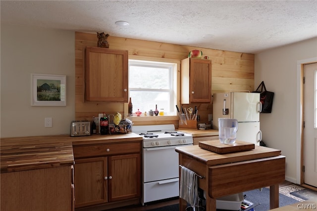 kitchen with white appliances and a textured ceiling