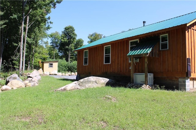 view of home's exterior featuring a shed and a yard