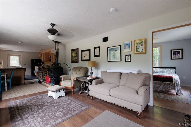 living room with hardwood / wood-style flooring and a textured ceiling