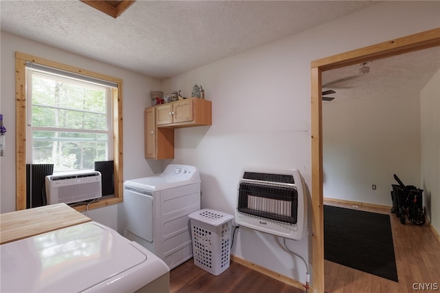 washroom featuring cabinets, a textured ceiling, separate washer and dryer, dark hardwood / wood-style floors, and heating unit