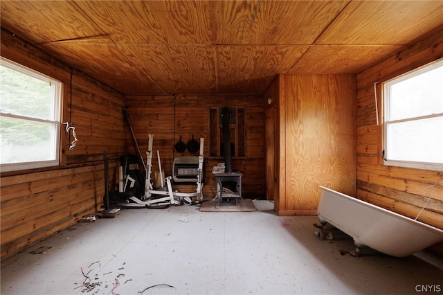 miscellaneous room with a wood stove and wooden walls