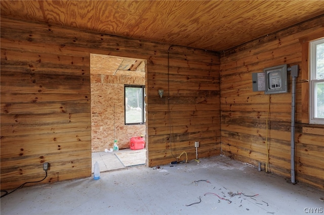 spare room featuring wood walls, plenty of natural light, and wood ceiling