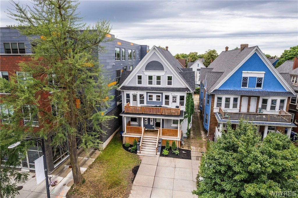 view of front of property with a balcony and covered porch