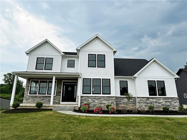 view of front of home with covered porch and a front lawn