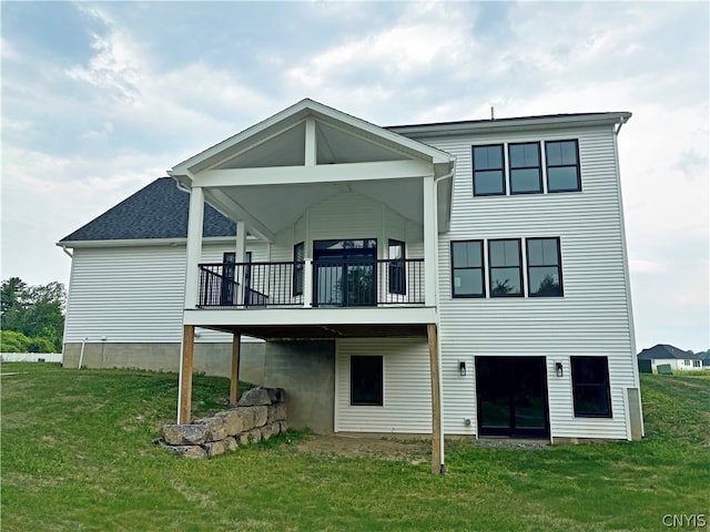 back of house with a wooden deck and a yard