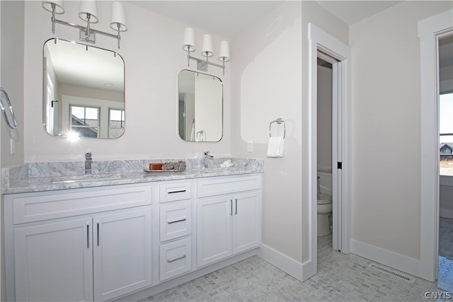 bathroom featuring toilet and vanity