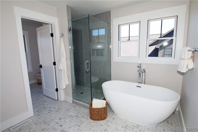 bathroom featuring tile patterned floors and shower with separate bathtub