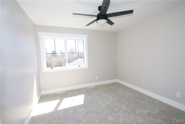 unfurnished room featuring light carpet and ceiling fan