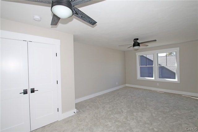 unfurnished bedroom featuring light carpet, a closet, and ceiling fan