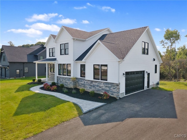 modern farmhouse style home with a front yard and a garage