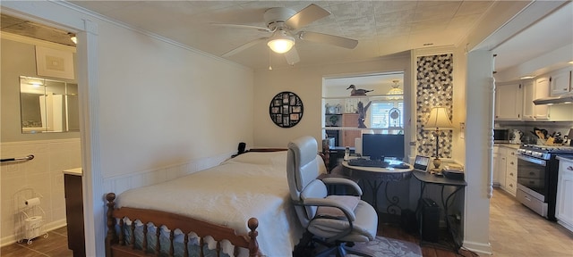 tiled bedroom with ornamental molding and ceiling fan