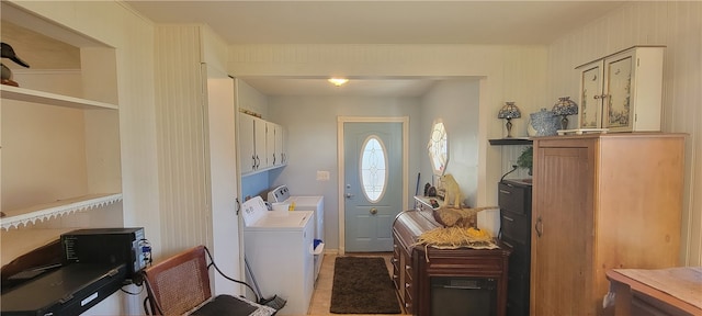 washroom with light tile patterned flooring, separate washer and dryer, and cabinets