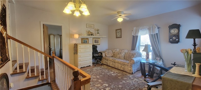 sitting room featuring hardwood / wood-style flooring and ceiling fan with notable chandelier