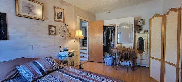 bedroom featuring a closet, washer / clothes dryer, and hardwood / wood-style flooring