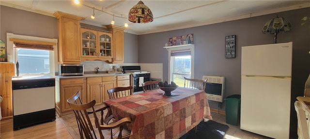 kitchen featuring tasteful backsplash, rail lighting, white appliances, ornamental molding, and light hardwood / wood-style floors