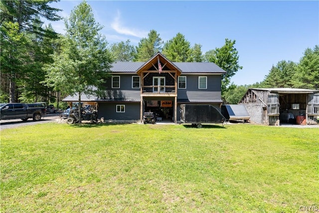 rear view of house featuring a lawn