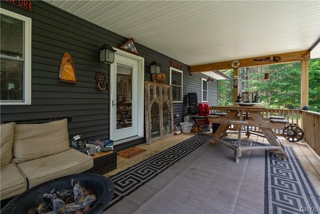 view of patio with an outdoor fire pit and a porch