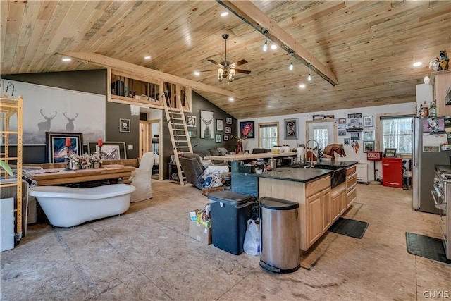 kitchen with wood ceiling, rail lighting, beam ceiling, plenty of natural light, and light brown cabinetry