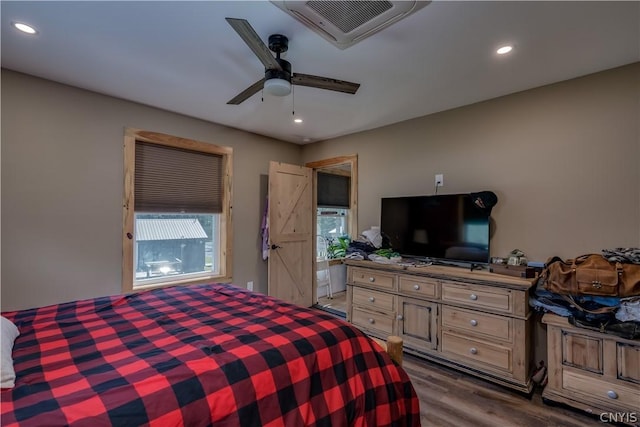 bedroom with wood-type flooring and ceiling fan