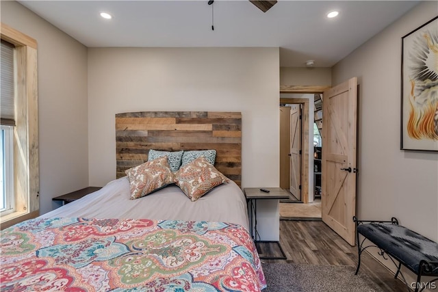 bedroom with ceiling fan and dark hardwood / wood-style floors