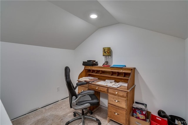 carpeted office space featuring vaulted ceiling