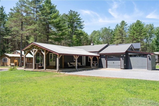 view of front of property featuring a porch, a garage, and a front lawn