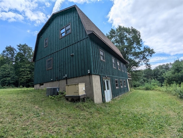 view of outdoor structure with central AC and a lawn