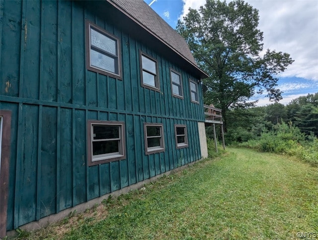 view of side of home with a yard